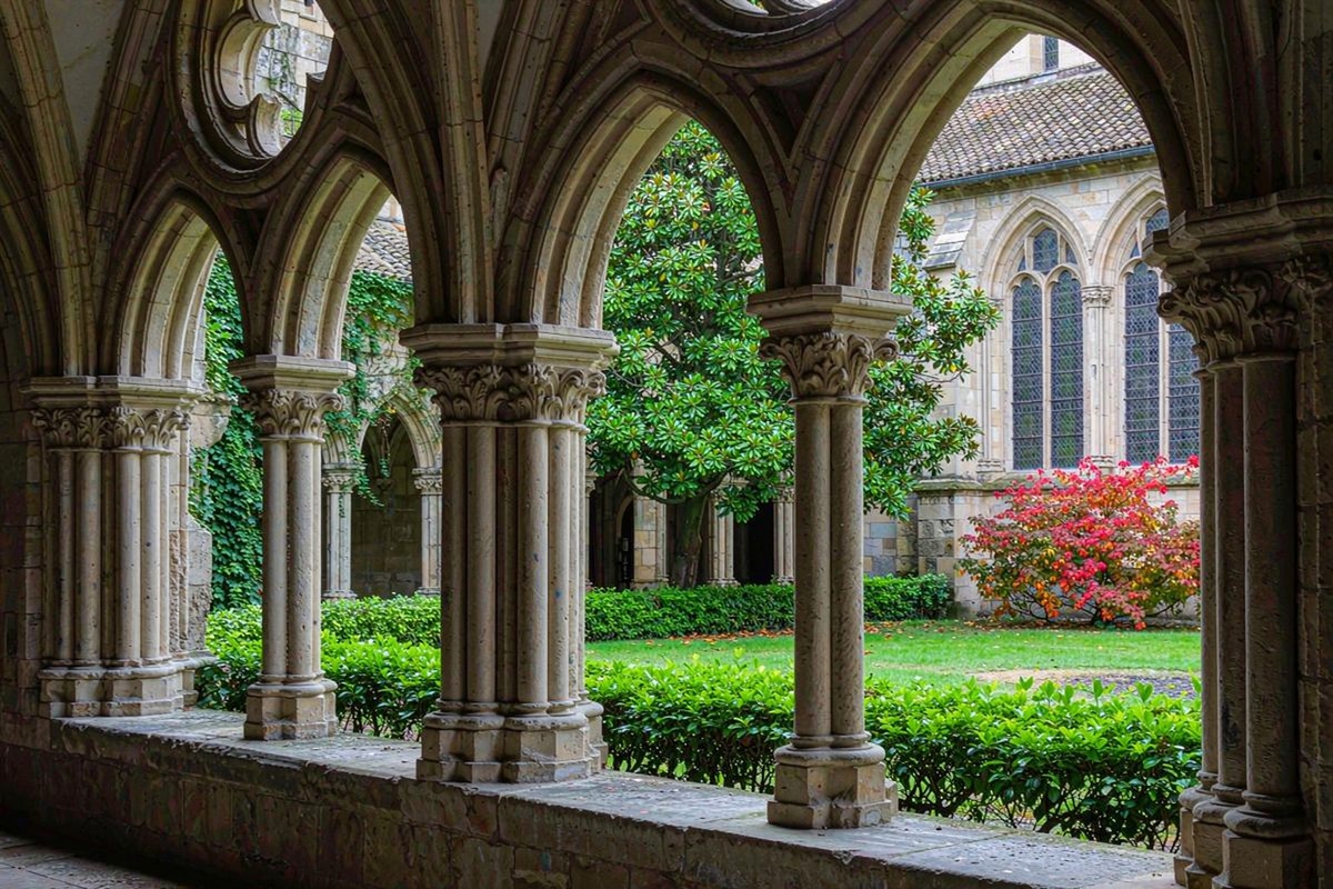 Quiet cloister garden with stone arches